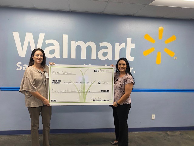 Wiregrass and Walmart staff holding donation